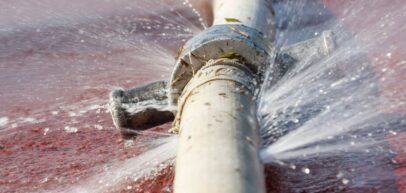 water gushing out of broken pipe